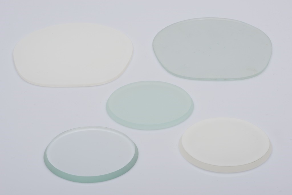 Sample discs of white flashed opal glass