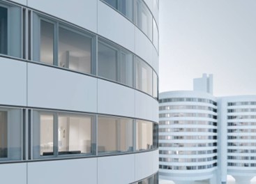Hospital façade with curved insulated glass panels used in energy-efficient renovation project in Germany